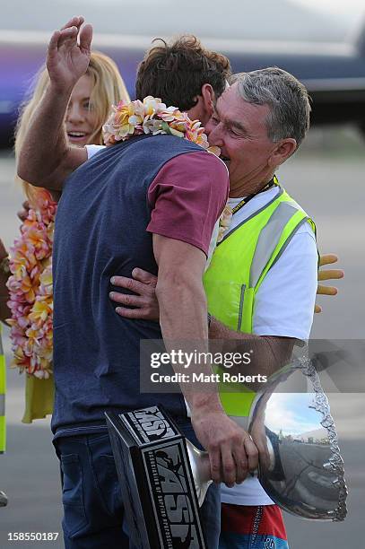 Australian surfer Joel Parkinson hugs is father Bryann as he arrives home at the Gold Coast airport on December 19, 2012 on the Gold Coast,...