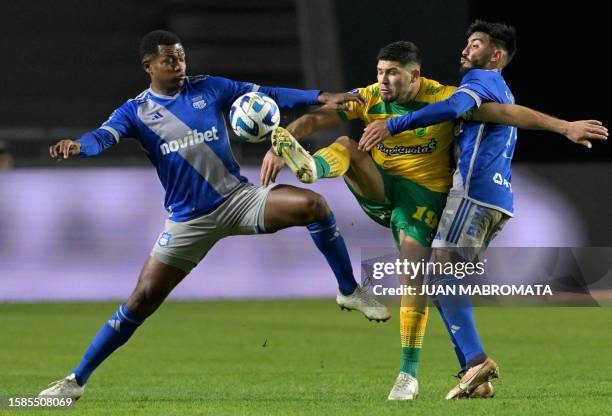Defensa y Justicia's forward David Barbona fights for the ball with Emelec's midfielder Romario Caicedo and Emelec's Argentine midfielder Carlos...