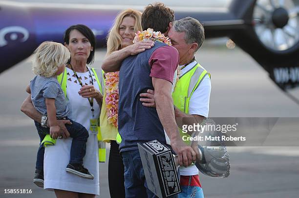Australian surfer Joel Parkinson hugs is father Bryan as he arrives home at the Gold Coast airport on December 19, 2012 on the Gold Coast, Australia....