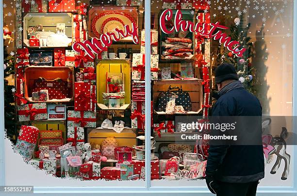 Pedestrian browse goods in the Christmas window display of a store in Bournemouth, U.K., on Wednesday, Dec. 12, 2012. Retailers are relying on...