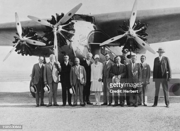 Passengers of the inaugural passenger flight from Los Angeles to San Francisco stand in front of a tri-motor Fokker F-10 airplane operated by Western...