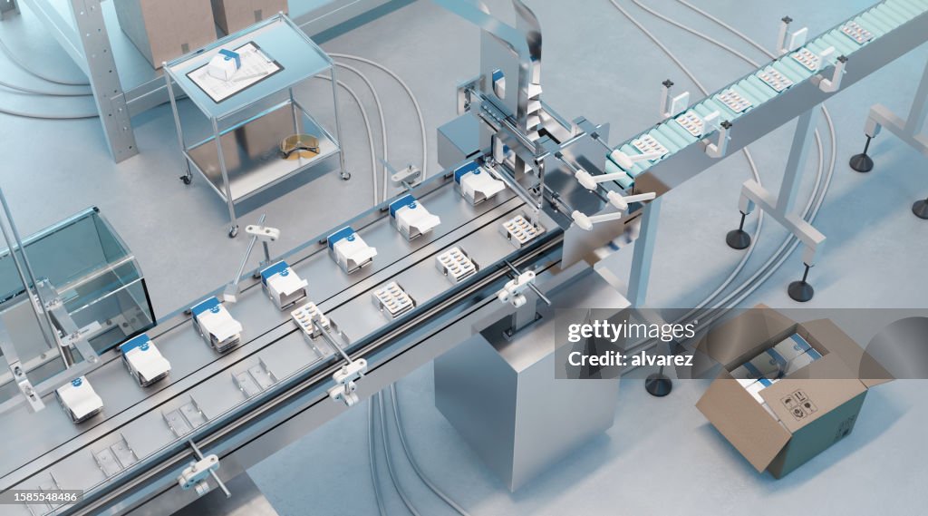 High angle view of automated packaging line conveyor belt in pharmaceutical factory