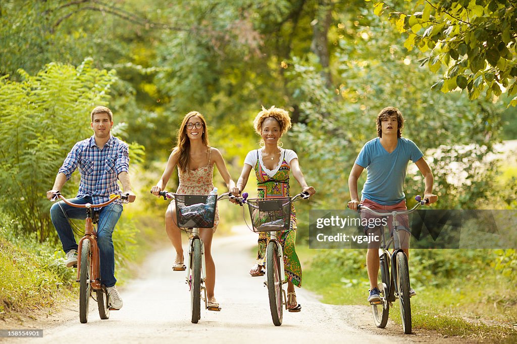 Friends Riding Bikes Happy Friends Riding Bicycles In A Nature High-Res Stock Photo - Getty ...