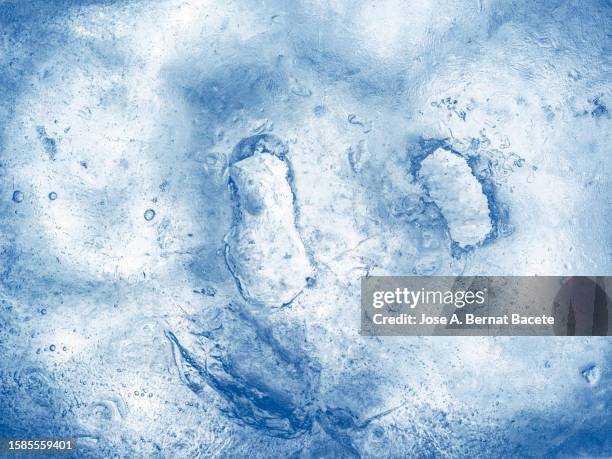 full frame of texture of a surface of frozen water of blue hue. - freeze ideas stock pictures, royalty-free photos & images