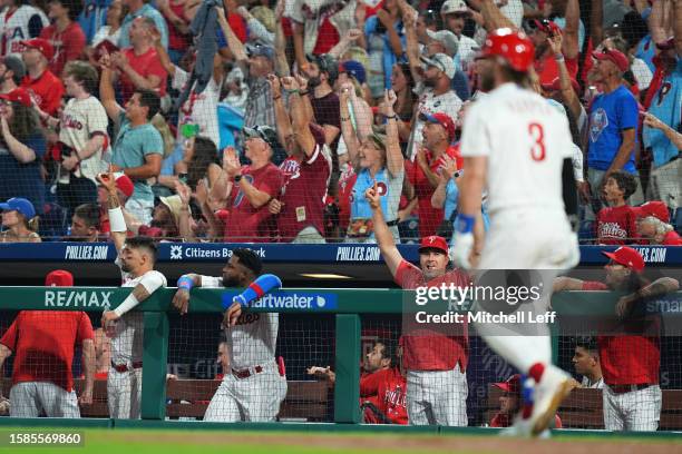 Nick Castellanos and J.T. Realmuto of the Philadelphia Phillies react after a two-run home run by Bryce Harper in the bottom of the fifth inning...