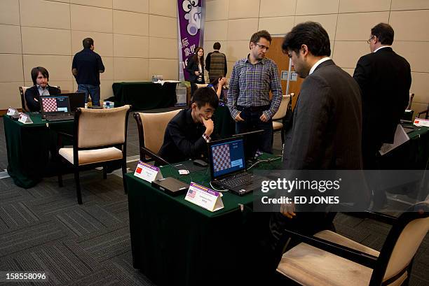 Chess players take their seats as they prepare to compete in a 'blinfold' chess tournament at the Beijing 2012 World Mind Games Tournament in Beijing...