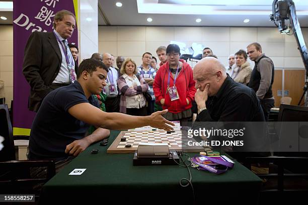 Allan Igor Moreno Silva of Brazil competes against Anatoli Gantwarg of Belarus during a draughts competition at the Beijing 2012 World Mind Games...