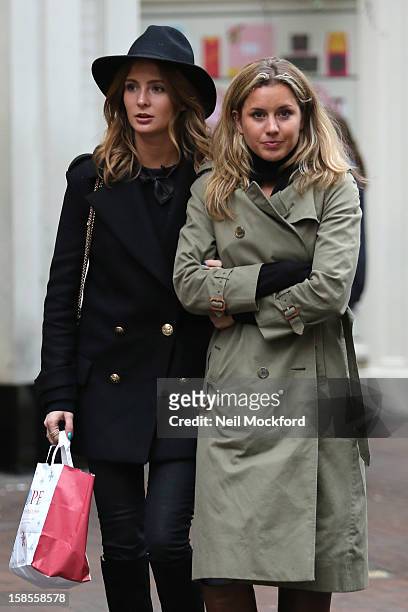Millie Mackintosh and Caggie Dunlop seen filming on Carnaby St on December 19, 2012 in London, England.