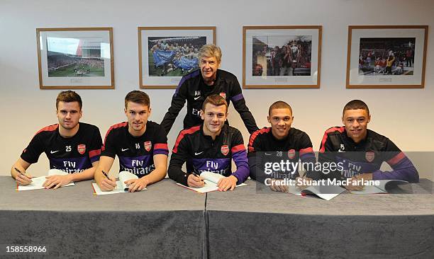 Manager Arsene Wenger of Arsenal stands over Carl Jenkinson, Aaron Ramsey, Jack Wilshere, Kieran Gibbs and Alex Oxlade-Chamberlain of Arsenal as they...