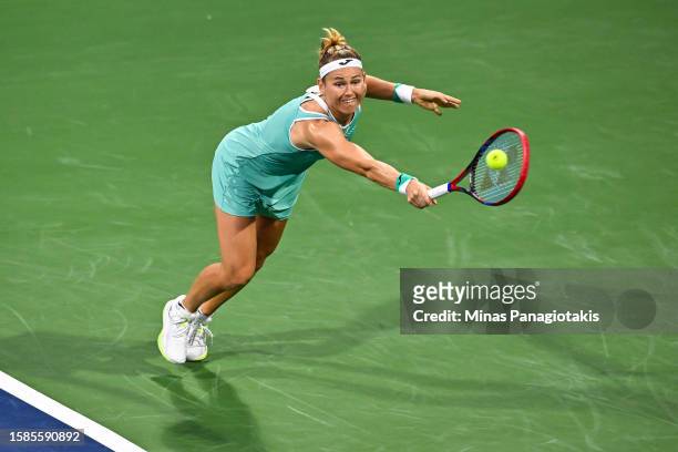 Marie Bouzkova of the Czech Republic hits a return against Caroline Garcia of France on Day 2 during the National Bank Open at Stade IGA on August 8,...