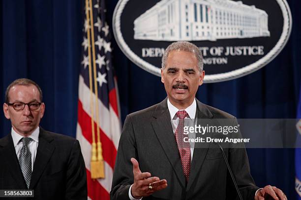 Attorney General Eric Holder speaks during a news conference at the Justice Department as Assistant Attorney General of the Criminal Division Lanny...