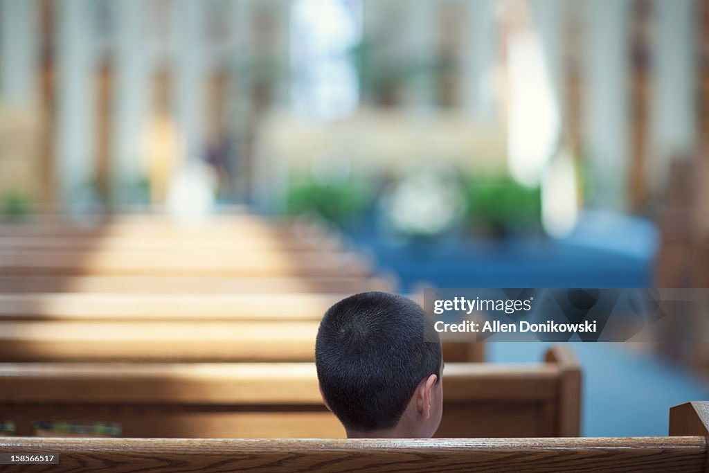 Child sitting alone in church