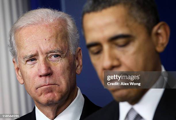 Vice President Joseph Biden listens as U.S. President Barack Obama speaks during an announcement on gun reform in the Brady Press Briefing Room of...