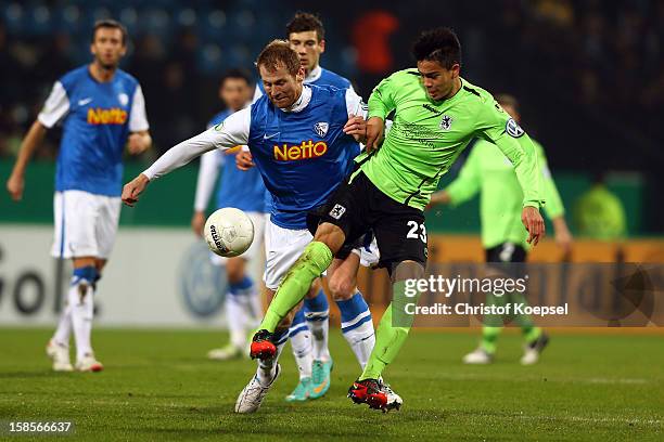 Lukas Sinkiewicz of Bochum challenges Bobby Wood of Muenchen during the DFB cup round of sixteen match between VfL Bochum and 1860 Muenchen at...