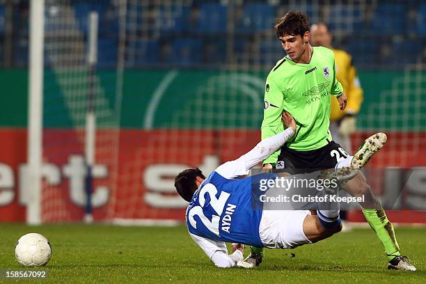 Christoph Schindler of Muenchen challenges Mirkan Aydin of Bochum during the DFB cup round of sixteen match between VfL Bochum and 1860 Muenchen at...