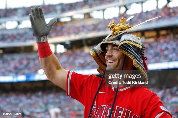 Randal Grichuk of the Los Angeles Angels reacts while wearing a samurai Kabuto helmet after hitting a home run during the fourth inning against the...