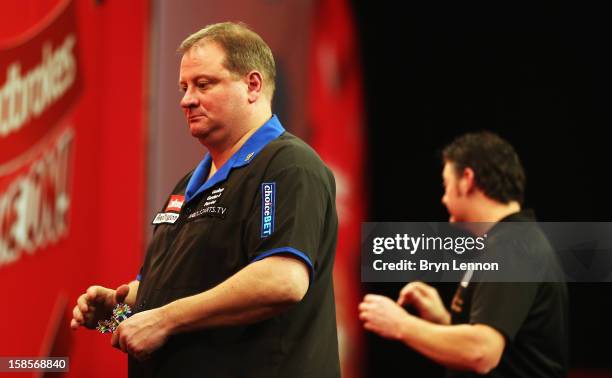 Andy Jenkins of England reacts during day 6 of the 2013 Ladbrokes.com World Darts Championship at Alexandra Palace on December 19, 2012 in London,...