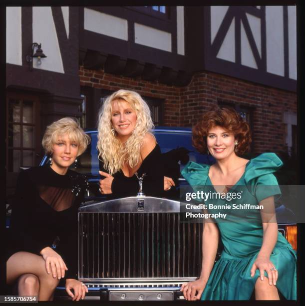 Actors Heather Locklear, Suzanne Somers and Deborah Adair pose on a Rolls Royce in costume for the TV movie Rich Men, Single Womenin Los Angeles in...