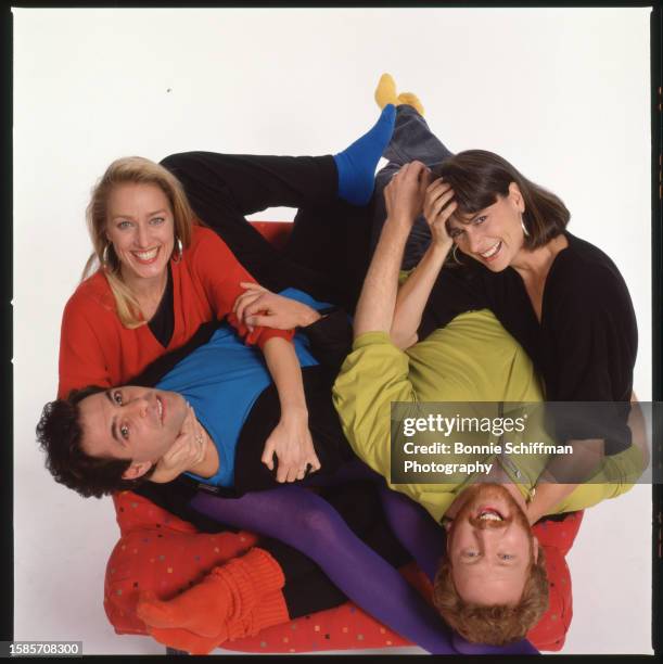 The cast of tv show Thirtysomething look up from a chair where they are piled on top of one another in Los Angeles in 1988.