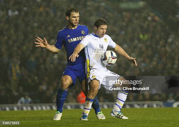 David Norris of Leeds United competes with Branislav Ivanovic of Chelsea during the Capital One Cup Quarter-Final match between Leeds United and...
