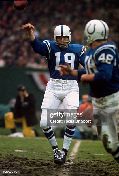 Quarterback Johnny Unitas of the Baltimore Colts throws a pass to Don Nottingham during an NFL football game circa 1971 at Memorial Stadium in...