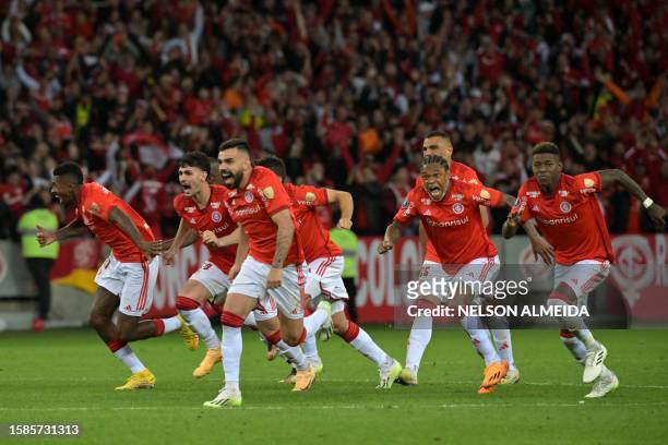 Players of Internacional celebrate after defeating River Plate 9-8 in the penalty shoot-out during the Copa Libertadores round of 16 second leg...