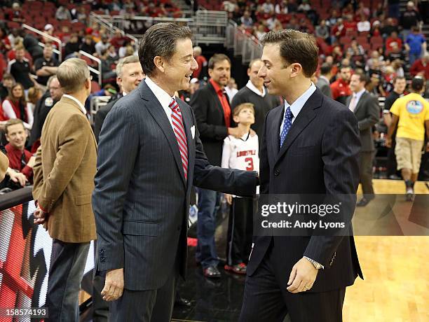 Rick Pitino the head coach of the Louisville Cardinals and Richard Pitino the head coach of the Florida International Panthers meet before the game...