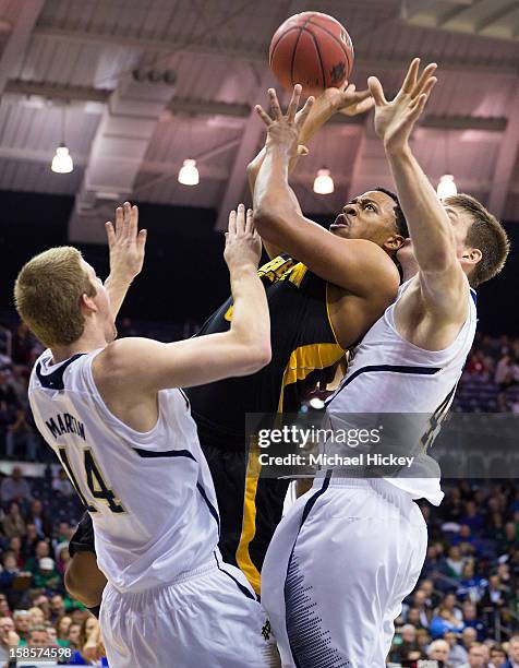 Brandon Dawson of the Kennesaw State Owls shoots the ball against Scott Martin of the Notre Dame Fighting Irish at Purcel Pavilion on December 19,...