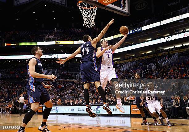 Goran Dragic of the Phoenix Suns lays up a shot past Jeffery Taylor of the Charlotte Bobcats during the NBA game at US Airways Center on December 19,...