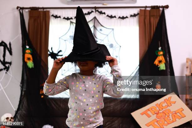 adorable african american boy wearing halloween costumes  standing  at home with decorate for a night party - witch hat stock pictures, royalty-free photos & images