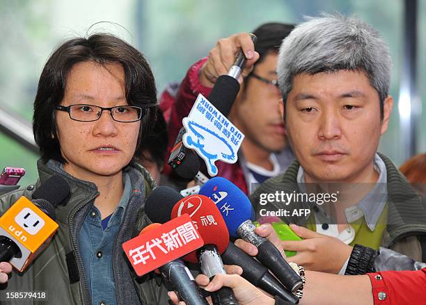 Rights activist Shawn Wu speaks while activist Ho Tsung-hsun looks on during a press conference about a court ruling on gay marriage, outside the...