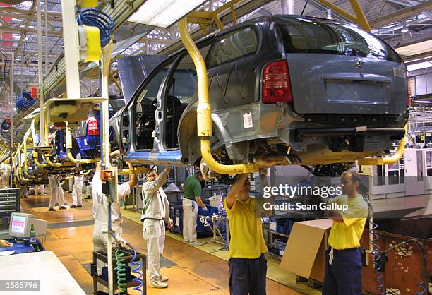 Workers assemble Skoda Octavia cars at the Skoda plant November 4, 2002 in Mlada Boleslav, Czech Republic. Czech carmaker Skoda, which is mainly...