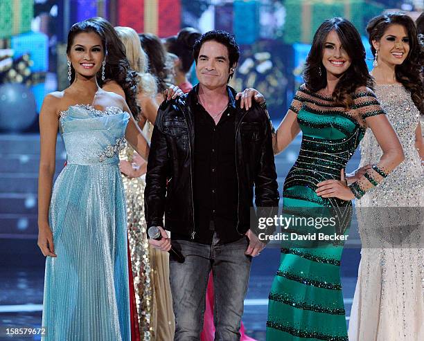 Train singer Pat Monahan is flanked by Miss Philippines 2012, Janine Tugonon , and Miss Venezuela 2012, Irene Sofia Esser Quintero, as he performs...
