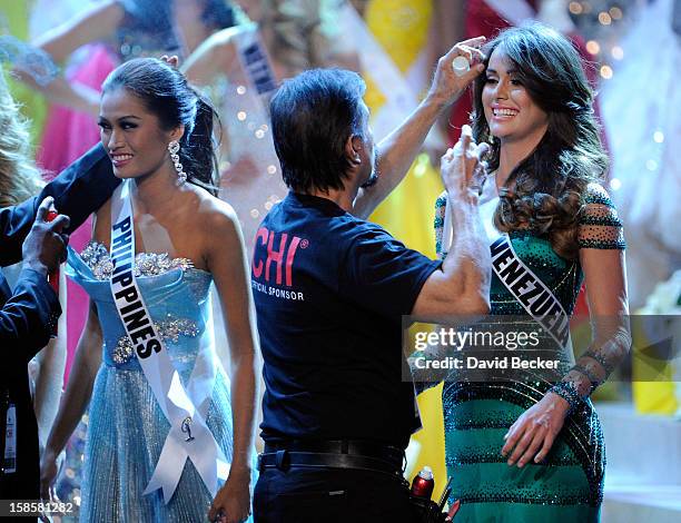 Miss Philippines 2012, Janine Tugonon , and Miss Venezuela 2012, Irene Sofia Esser Quintero, have their hair tended to during a commercial break in...