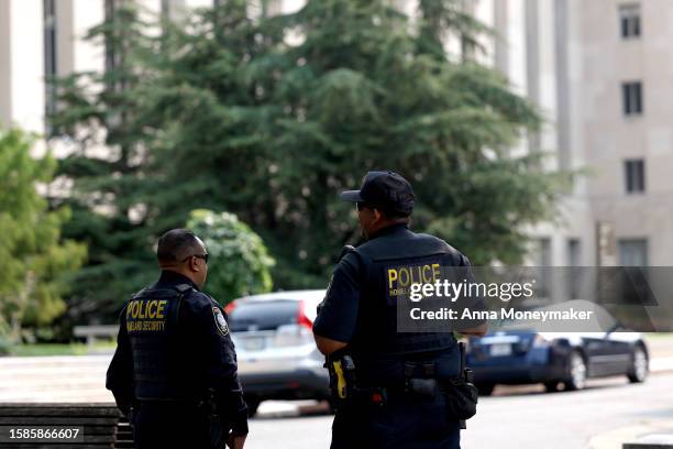 Police officers with the Department of Homeland Security stand in front of the E. Barrett Prettyman U.S. District Court House on August 01, 2023 in...