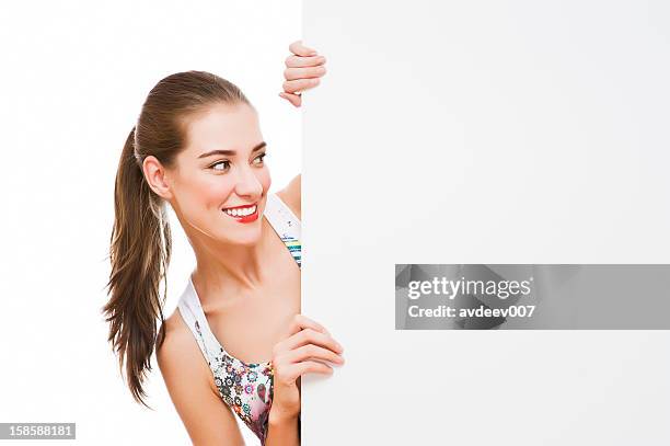 woman holding signboard - gluren stockfoto's en -beelden