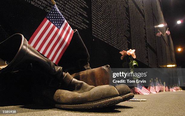 Bikers boots, a wallet and the an American flag stand at rest at the base of The Vietnam Wall Experience, a traveling replica of the Vietnam...