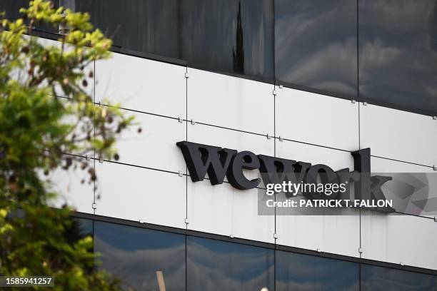 The WeWork logo is displayed outside of a shared commercial office space building in Los Angeles, California on August 8, 2023. Embattled...