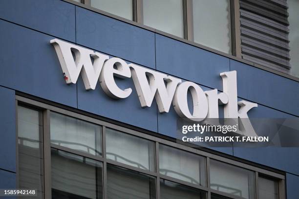 The WeWork logo is displayed outside of a shared commercial office space building in Los Angeles, California on August 8, 2023. Embattled...