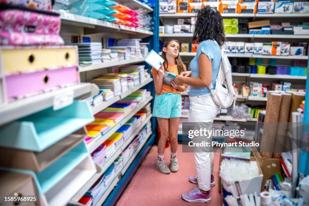 mother and daughter shopping school supplies in a store - pleading stock pictures, royalty-free photos & images