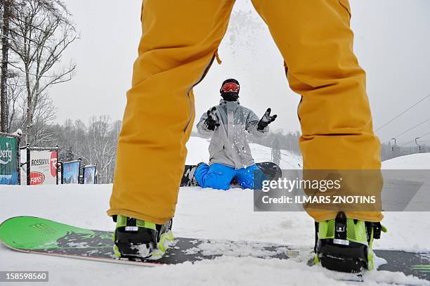 Janis Bendiks play's with snow at the top of Zagarkalns' main slope in Cesis, Latvia on December 5, 2012. In the flat Baltic nation of Latvia, where...