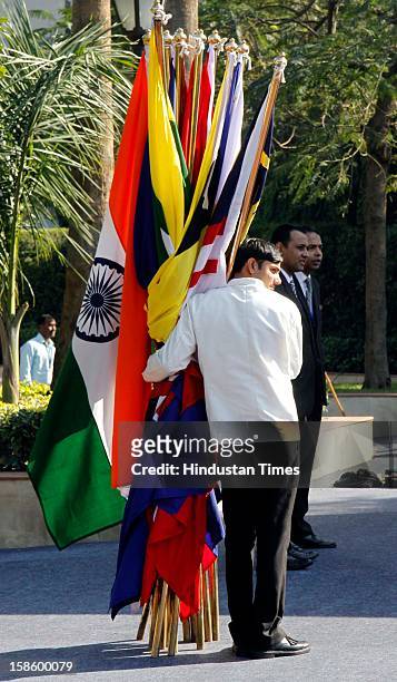 An worker holding the participating countries national flags to preparing for the group photo session during the ASEAN - India Commemorative Summit,...