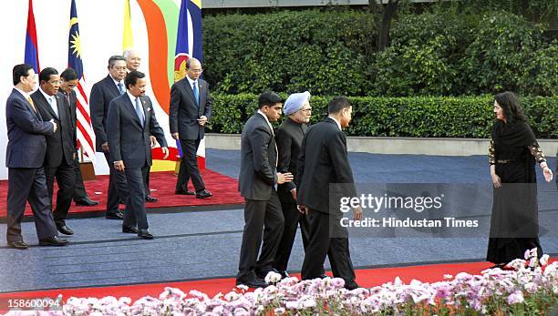 Indian Prime Minister Manmohan Singh leaving after the group photo session as participating country leaders following him during the ASEAN - India...