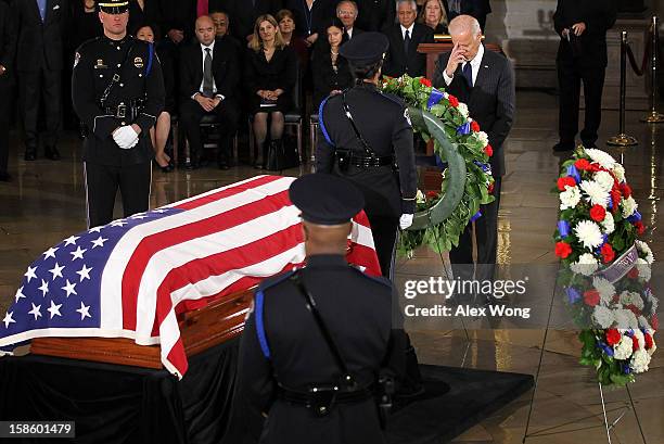 Vice President Joseph Biden places a wreath in front of the flag draped casket of Senator Daniel Inouye at the Rotunda of the U.S. Capitol during a...