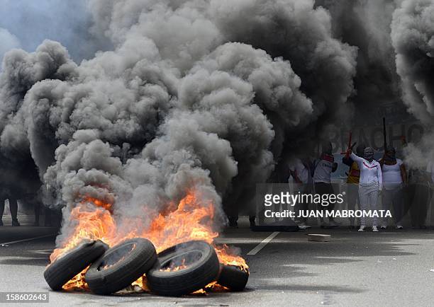 Members of Quebracho organization burn tires whie blocking 9 de Julio avenue on December 20, 2012 in Buenos Aires, during a demonstration on the 11th...