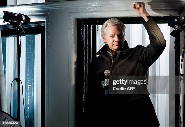 Wikileaks founder Julian Assange gestures as he addresses members of the media and supporters from the window of the Ecuadorian embassy in...