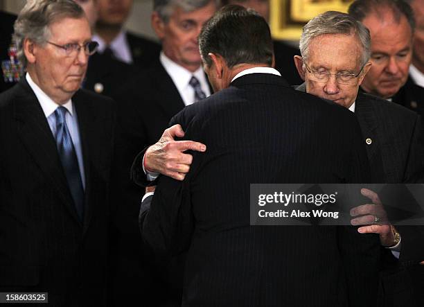 Senate Majority Leader Sen. Harry Reid hugs Speaker of the House Rep. John Boehner as Senate Minority Leader Sen. Mitch McConnell looks on as Senator...