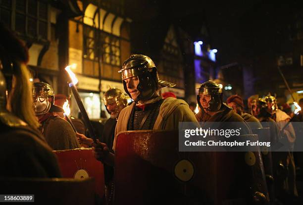 Re-enactors from the Roman Deva Victrix 20th Legion parade through the city of Chester as they celebrate the ancient Roman festival of Saturnalia on...