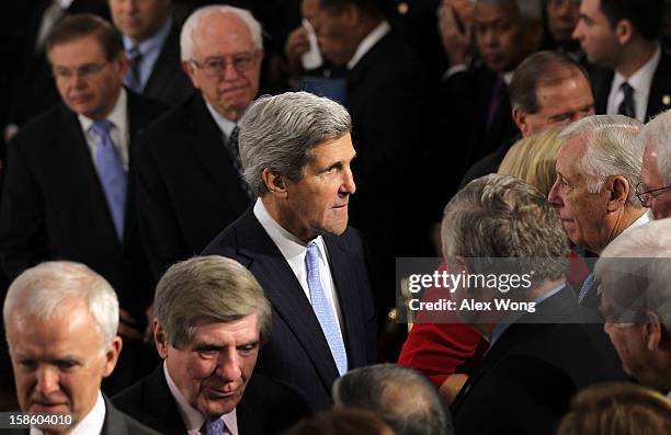 Senator John Kerry greets House Minority Whip Rep. Steny Hoyer and other congressional members as he wait in-line to bid farewell to Senator Daniel...