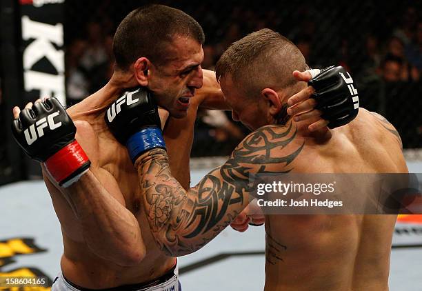 Ross Pearson punches George Sotiropoulos during their lightweight fight at the UFC on FX event on December 15, 2012 at Gold Coast Convention and...